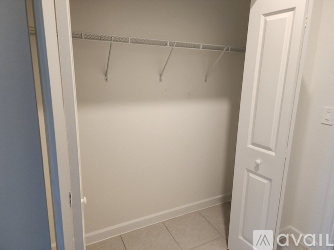 A white closet with a door and a hanger.