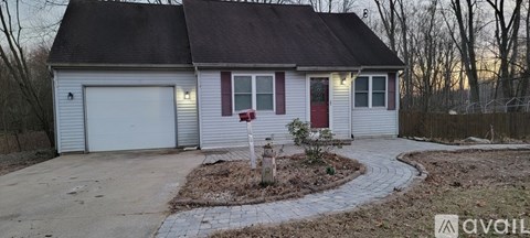 A house with a red door and a mailbox in front of it.