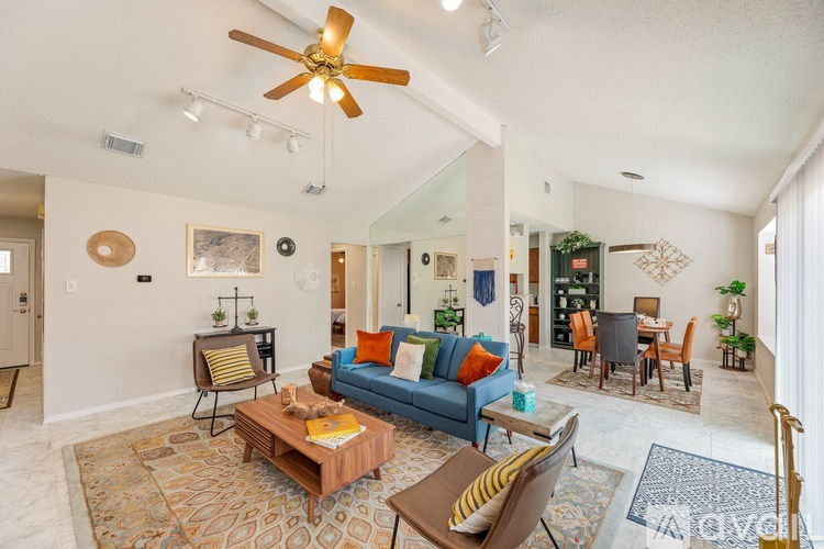 A living room with a blue couch and a wooden coffee table.