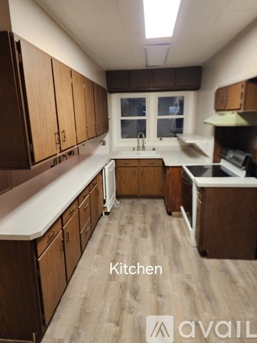 A kitchen with wooden cabinets and a white countertop.
