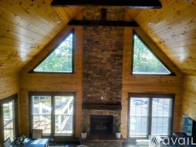 A living room with a fireplace and a stone wall.