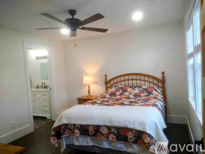 A bedroom with a floral bedspread and a wooden bed.
