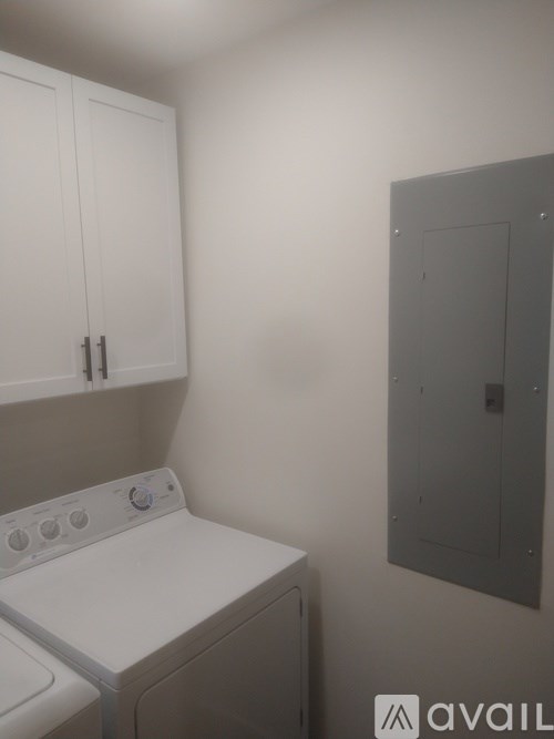 A small laundry room with a washer and dryer.