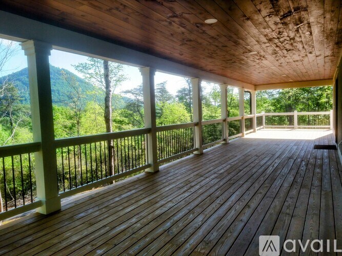 A wooden deck with a mountain view in the distance.