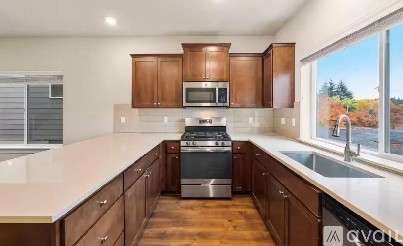 A kitchen with wooden cabinets and stainless steel appliances.