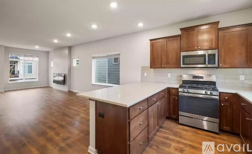 A kitchen with wooden cabinets and a stainless steel oven.