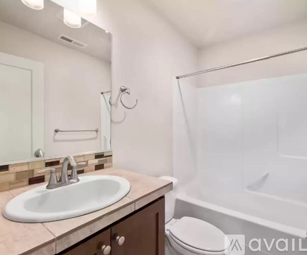 A bathroom with a sink, toilet, and bathtub.