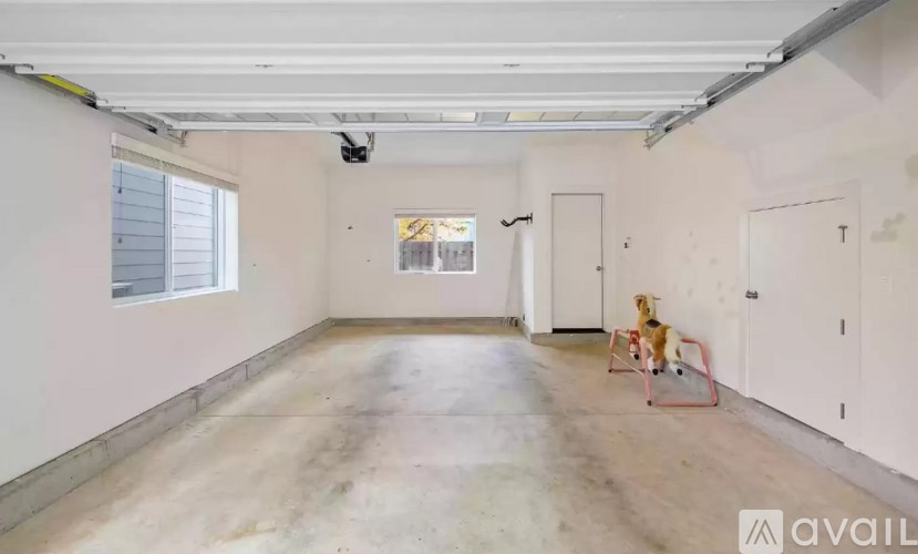 A room with a dog in a red cage.