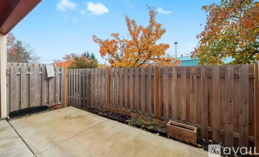 A wooden fence with a tree in the background.
