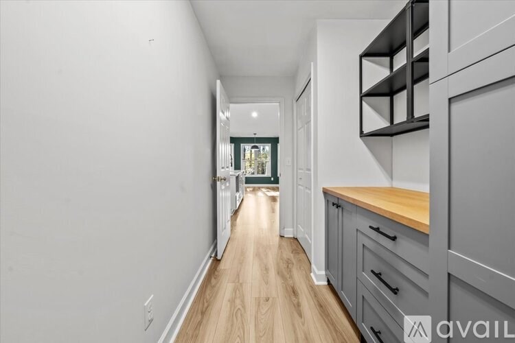 A long hallway with a kitchen area on the right.