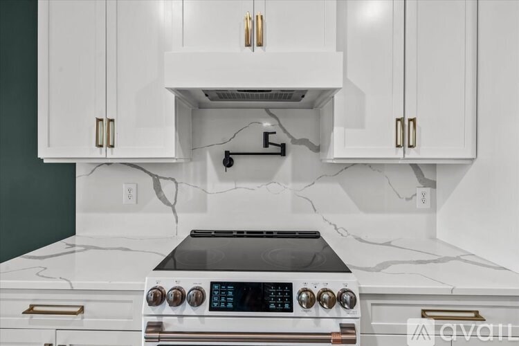 A modern kitchen with a white oven and cabinets.