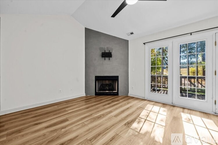 A room with a fireplace and a ceiling fan.