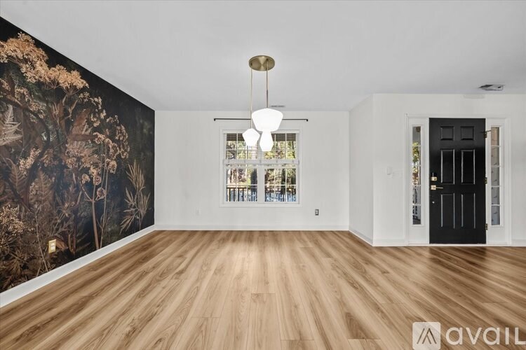 A room with a large mural on the wall and a wooden floor.