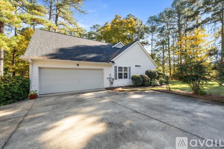 A house with a white garage door is for sale.