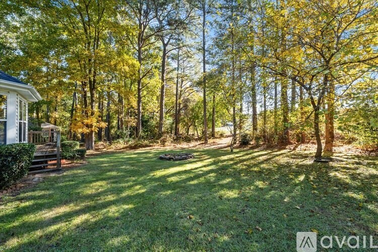 A house is surrounded by trees with yellow leaves.