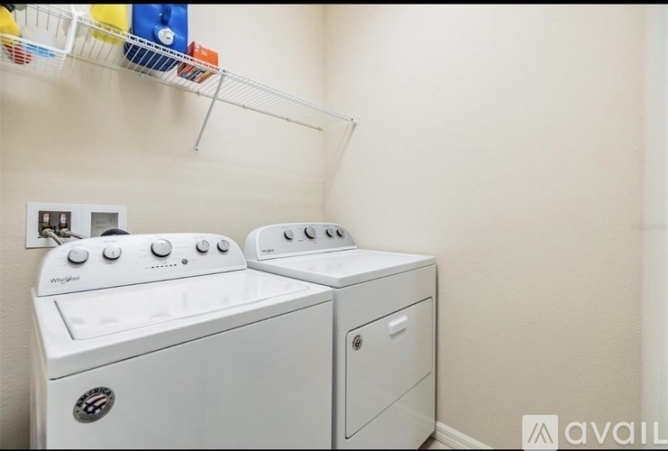 A white washing machine and dryer in a small laundry room.