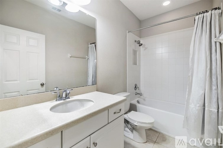 A bathroom with a sink, toilet, and bathtub.