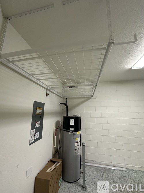 A room with a white ceiling and a grey water heater.