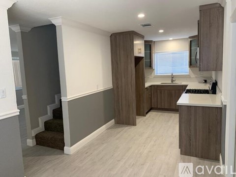 A kitchen with wooden cabinets and a white countertop.