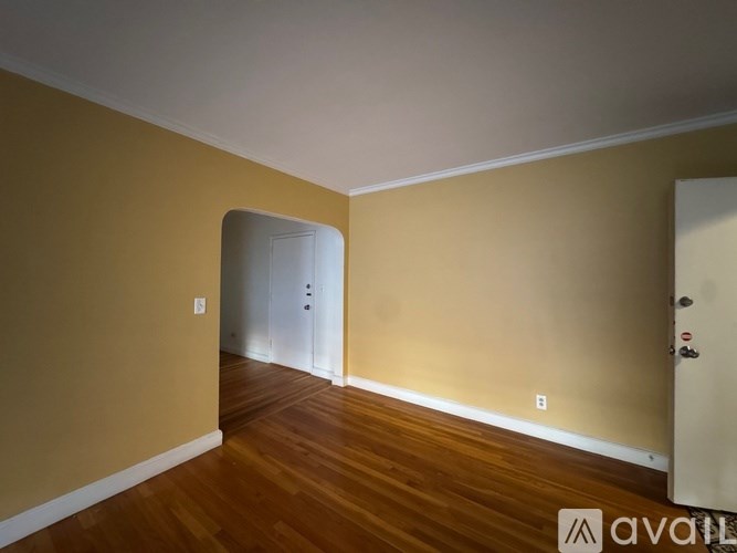 A room with wooden floors and a white door.