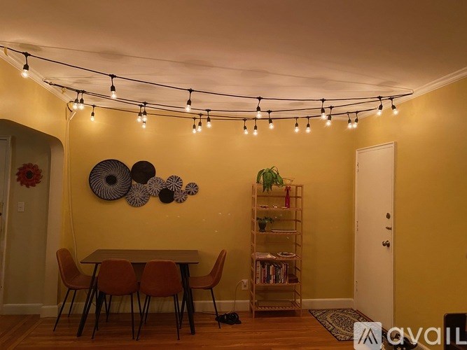 A dining room with a table, chairs, and wall decor.