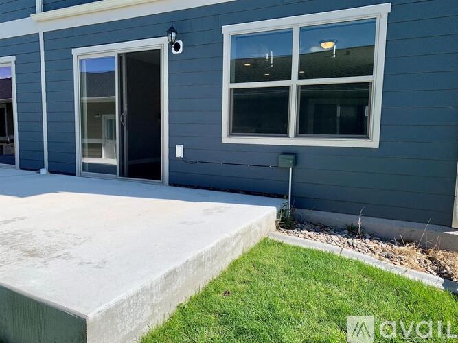 A blue house with a black door and a window.