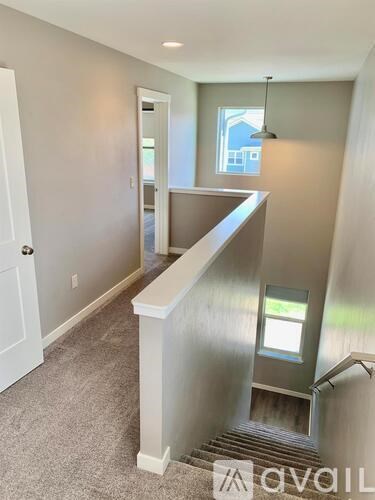 A hallway with a staircase leading to the second floor.
