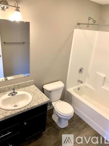 A bathroom with a sink, toilet, and bathtub.