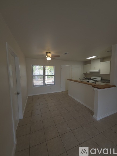A kitchen area with a window and a counter.