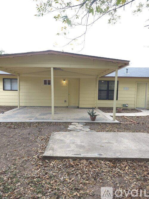 A small house with a porch and a door.