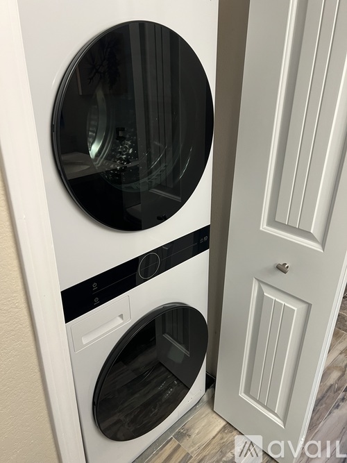 A white washing machine and dryer in a small laundry room.