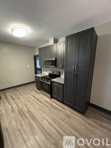 A kitchen with a stove top oven and a microwave.