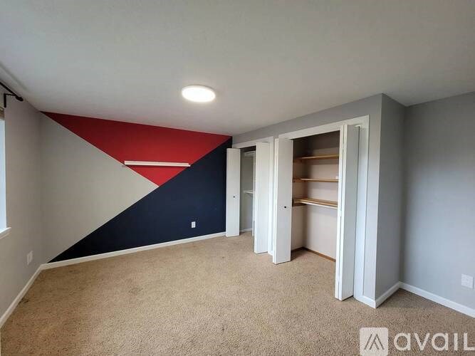 A room with a red, white and blue triangular design on the wall.