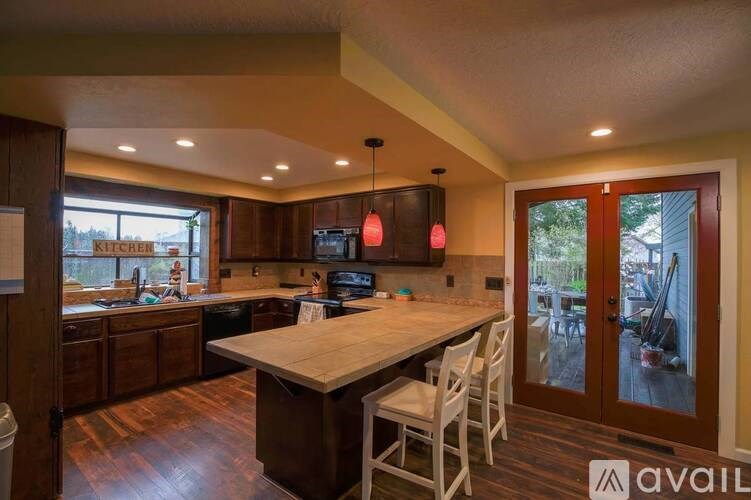 A kitchen with a table and chairs and a window.