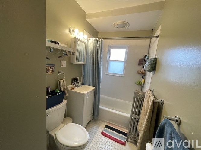 A bathroom with a toilet, sink, and shower.