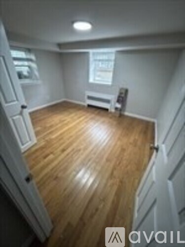 A room with wooden floors and white walls.