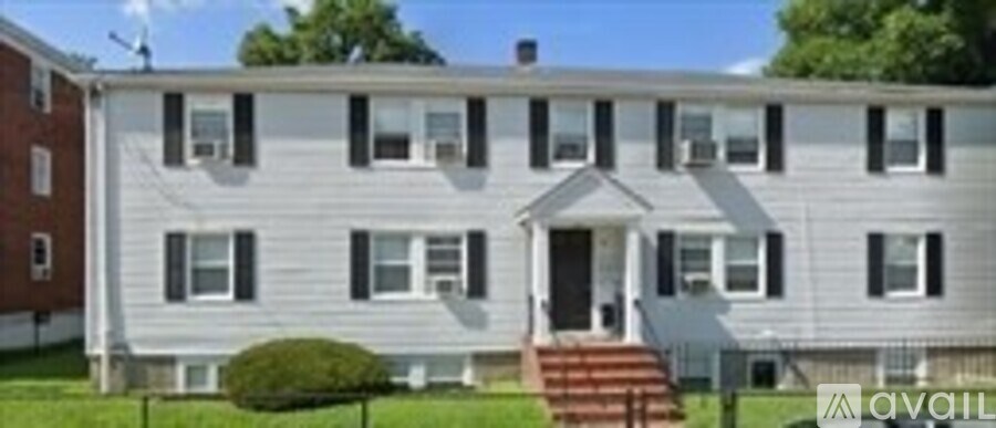 A white house with a red door and windows.