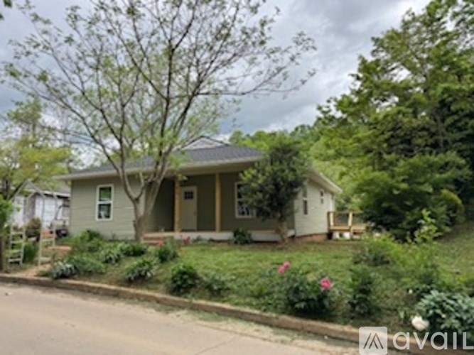 A house with a tree in front of it.