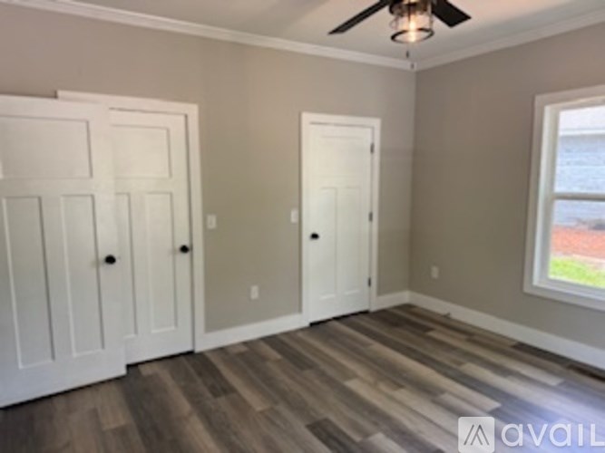 A room with a ceiling fan and a window.