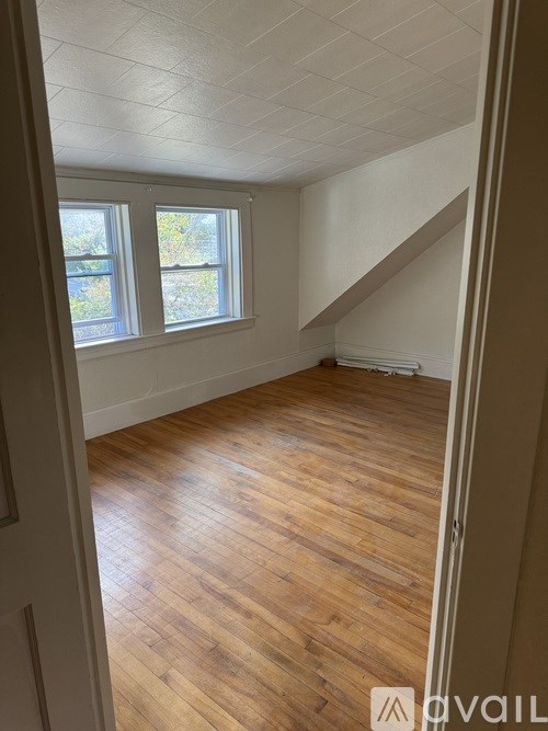 A room with wooden floors and a window.