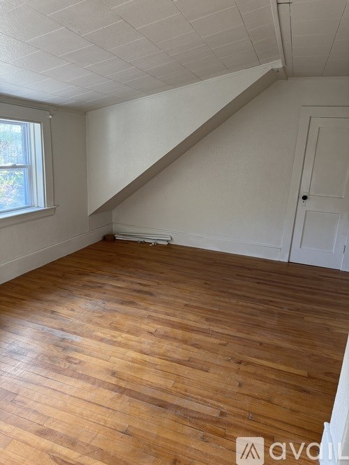 A room with wooden floors and a white ceiling.