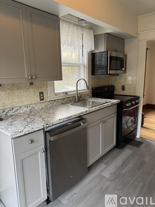A kitchen with granite countertops and a dishwasher.