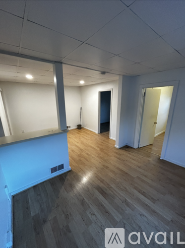 A room with wooden floors and white walls.