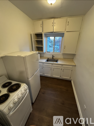 A small kitchen with a stove and cabinets.