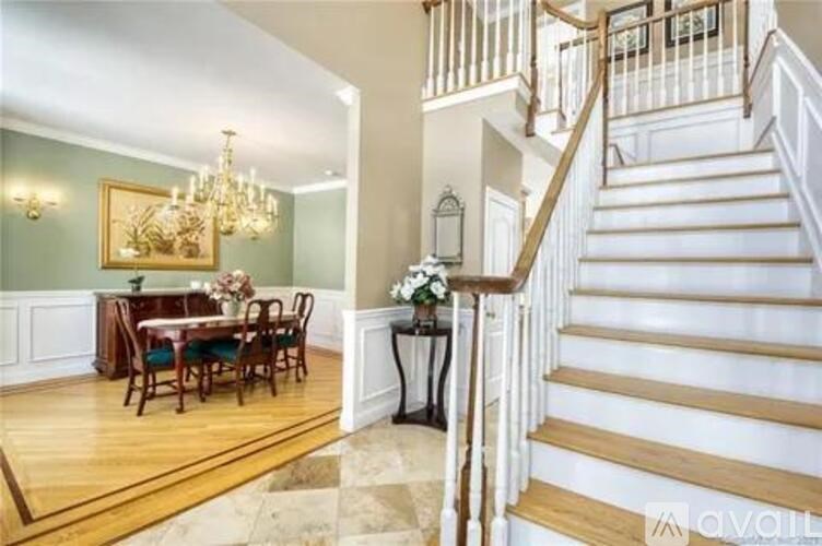 A room with wooden floors and a chandelier.