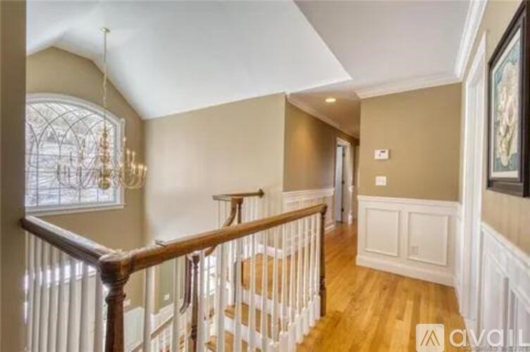 A large house with a driveway in front.