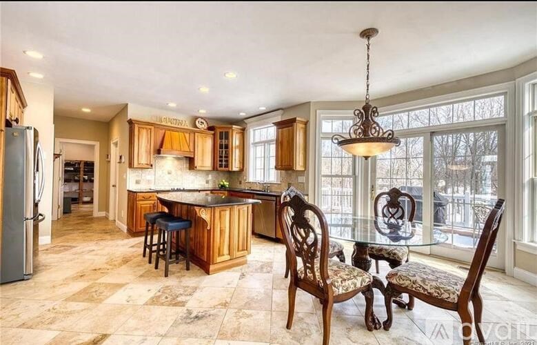 A kitchen with a bar area and a dining table.