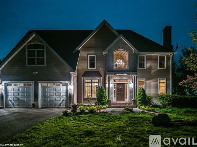 A house with a lit up sign that says "AVAIL" in front of it.