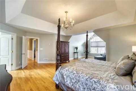 A kitchen with wooden cabinets and a marble island.