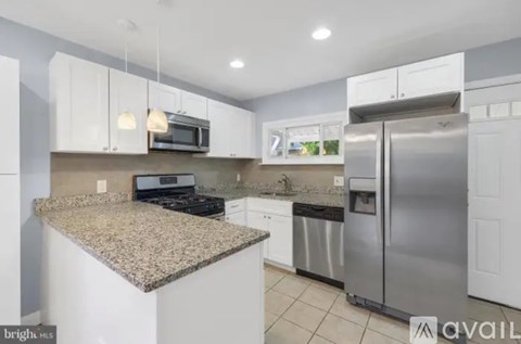 A kitchen with granite countertops and stainless steel appliances.